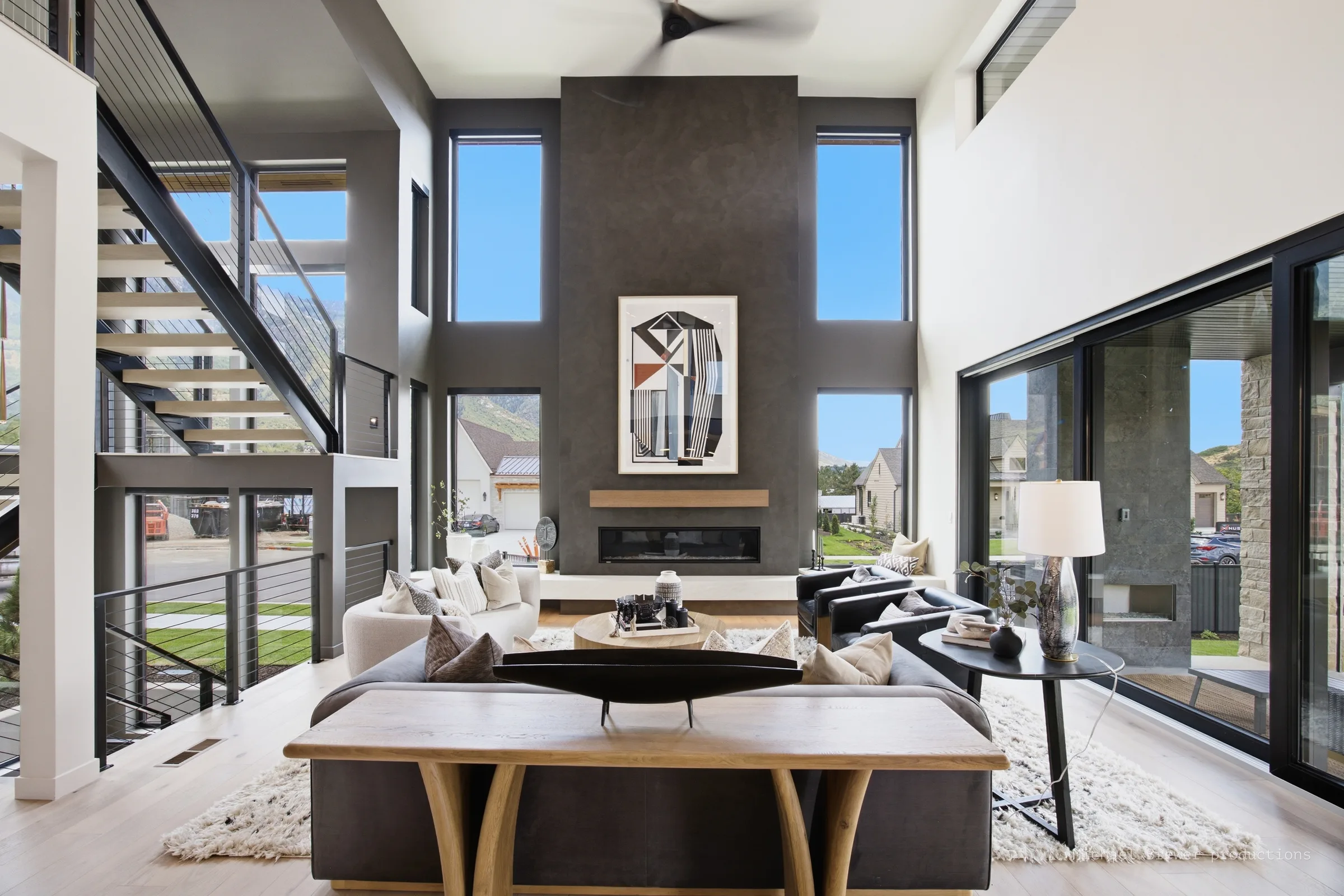 Living room surrounded by full-height windows and glazed doors